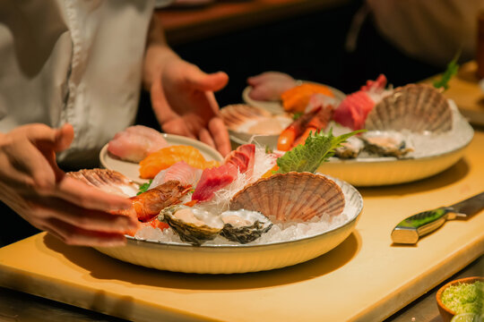 Sushi chef preparing fresh seafood platter with vibrant colors and textures
