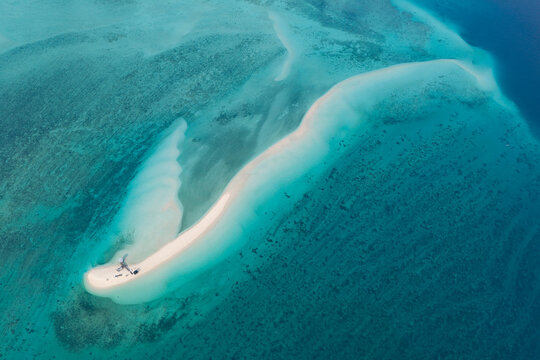 Seen from a bird's eye view, low tide exposes a scenic, sandy island amid the Derawan Archipelago of East Kalimantan, Indonesia. This beautiful area is a popular vacation destination.