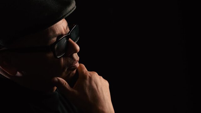 Profile of black man with hand on chin