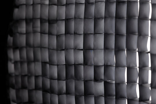 Black studio lighting softbox grid modifier abstract background with selective focus