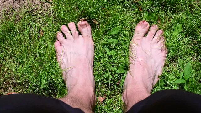 Grounding feet on the grass, copy space top down video, b roll, authentic real people