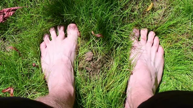 Grounding feet on the grass, copy space top down video, b roll, authentic real people