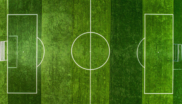 A vibrant aerial view of an empty soccer field with lush green turf and crisp white lines. This professional sports arena, featuring nobody, evokes a sense of anticipation, calm, and potential.