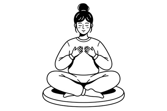 Young woman sitting cross legged meditating on cushion holding hands to chest