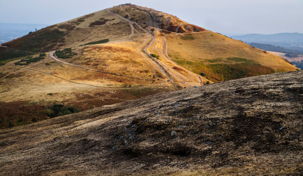 View of sun baked Worcestershire Beacon at sunset,atop the Malvern Hills,Worcestershire,England,UK.
