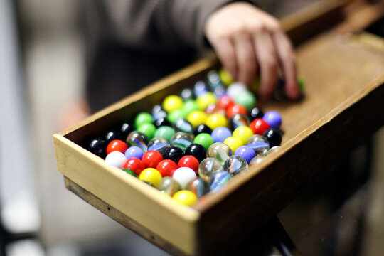 Little Kid Playing with Marbles