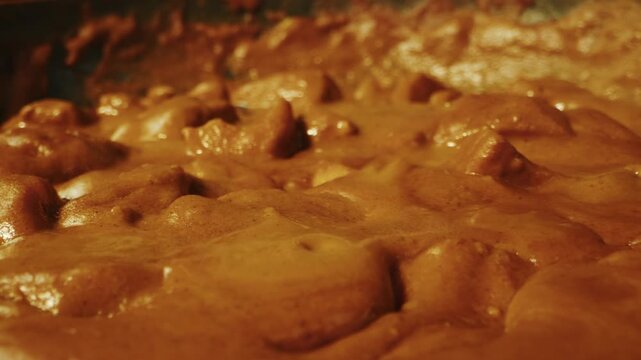Chicken tikka masala curry boiling in a pan at a professional restaurant kitchen, Indian and Japanese style spicy curry sauce simmering and preparation by a chef