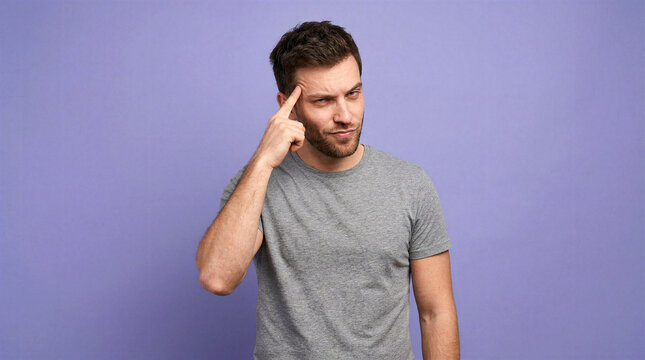 Man with a smirk taps his temple, indicating a clever idea or thought