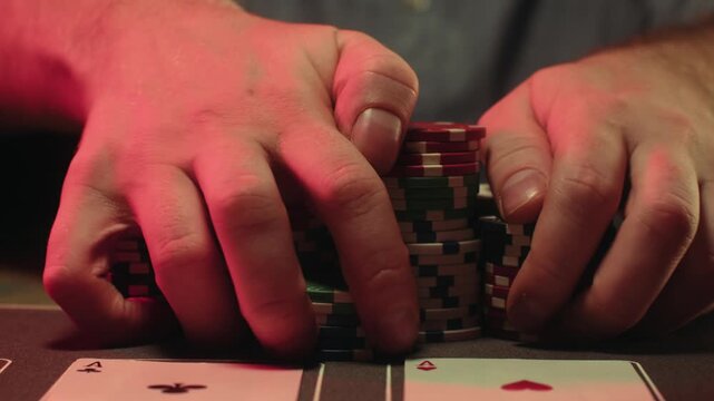 Casino player, Game of poker in casino, taking place with poker chips and cards on a green table betting chips, gambling place, roulette jack pot. All in bet game. 