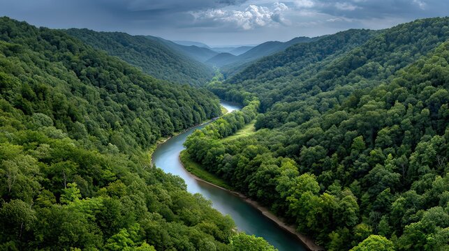 Serene River Flowing Through Lush Green Mountains Under Cloudy Sky in Scenic Nature Landscape
