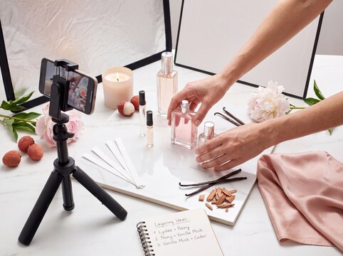 Creator style fragrance content setup with camera and perfume