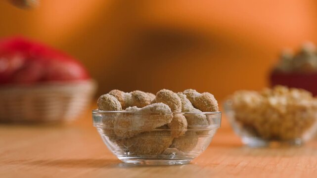Peanuts in Salted Shell Man Cracking and Eating Salty Nuts as a Classic Bar Snack at Cafe