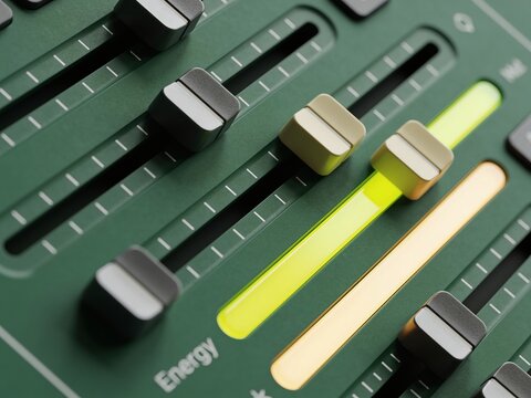 Close up shot of professional audio mixer featuring long neon yellow and green fader rails, numerous sliders and knobs, and