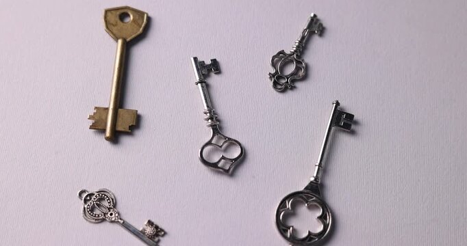 Different keys on light grey background, top view
