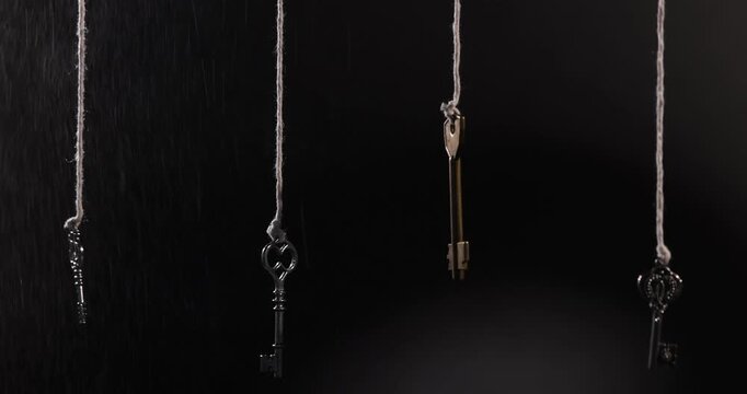 Choice concept. Different keys hanging against black background
