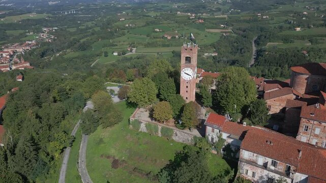 Mondov&igrave; hill top old town and medieval clock tower with Italian flag aerial orbit and panoramic view, Piedmont