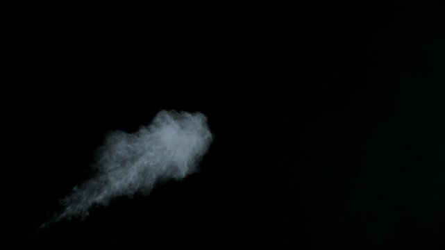 Super Slow Motion Shot of White Powder Blow Isolated on Black Background at 1000fps.