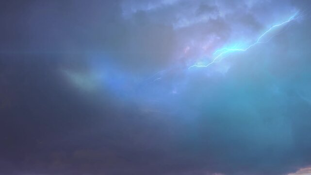 Dramatic Lightning Bolts Striking Through Stormy Blue Sky