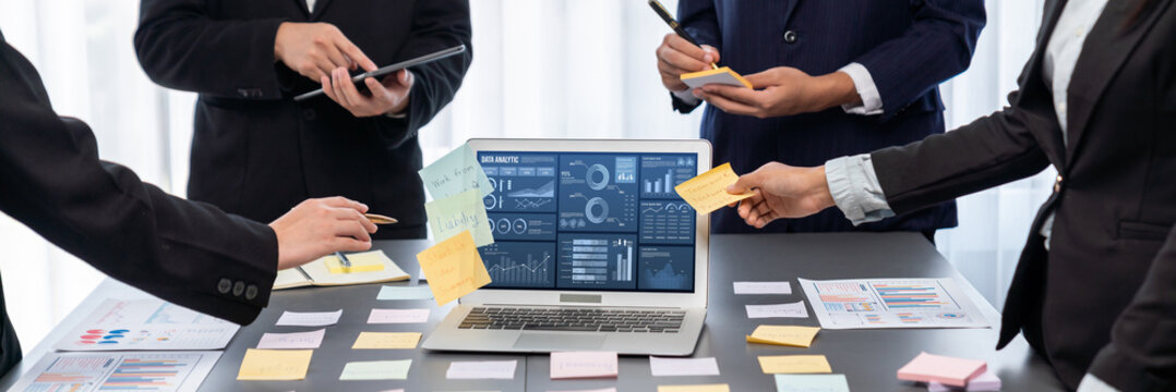 Analyst team use sticky note for creative and analytic brainstorm for business idea with BI data dashboard on laptop screen. Analysis financial data visualization tech for marketing strategy. Prodigy