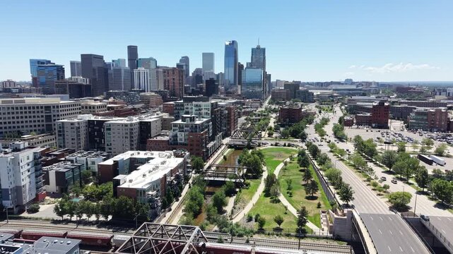 HIgh aerial view flying along the Cherry Creek trail parallel to N. Speer Blvd in downtown Denver, Colorado. 
