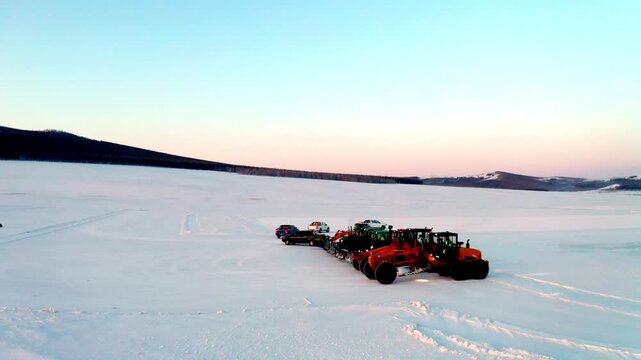 Snow Removal Machinery Lined Up on a Vast Frozen Plain