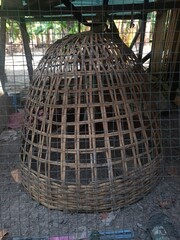 Traditional handmade bamboo chicken coop in a rural village. © Yusran