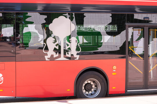 ZAPOPAN, MEXICO - AUGUST 28, 2026: Side view of red Mi Transporte public bus.
