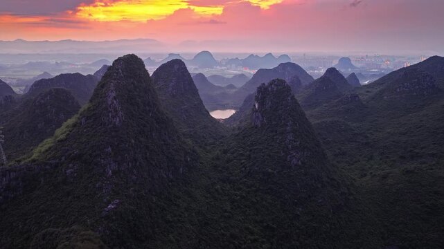 Scenic aerial view of Karst mountains and limestone peaks during sunset in Guilin, China.