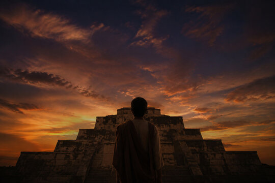 Lone figure before ancient ziggurat ruins at twilight, heritage and contemplation concept