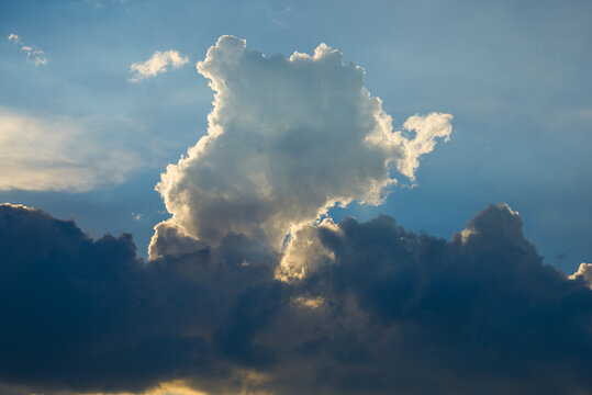 Huge white cumulonimbus clouds standing against the blue sky
