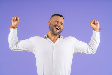Fototapeta premium Young adult man expressing intense emotion celebrating victory