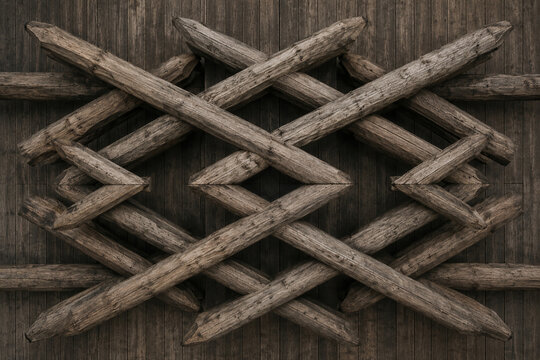 Geometric pattern of interlocking rough wooden beams forming a tight structure, top-down view.
