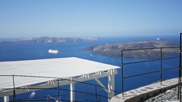 Santorini terrace and caldera view soft blurred bokeh seafront background outdoor; backdrop copyspace backplate template.