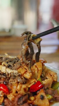 Vertical screen real shot of old friends from Nanning cooking beef offal with spicy rice