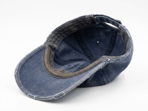 A faded old baseball cap with a warped brim