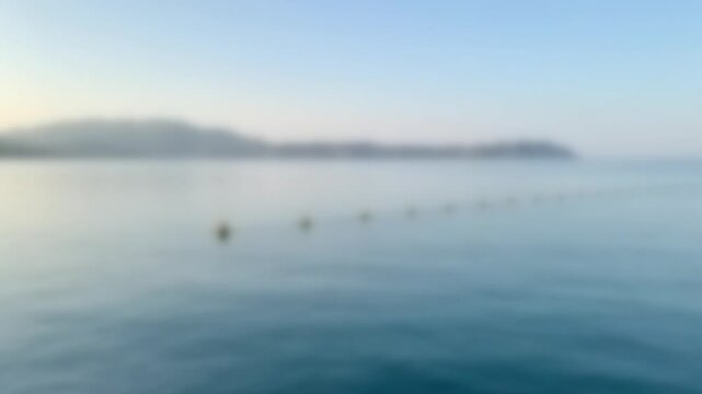 Marker buoys of a marine protected area on bright calm water, Full Gaussian Blur Abstract