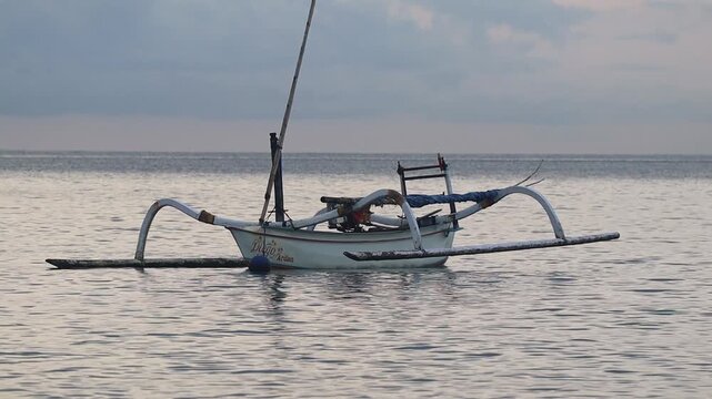 Close Up of Traditional Jukung Fishing Boat Anchored on Calm Water at Teluk Waru Lombok Beach