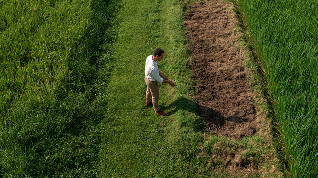 Farmer Comparing Biochar Soil Water Retention