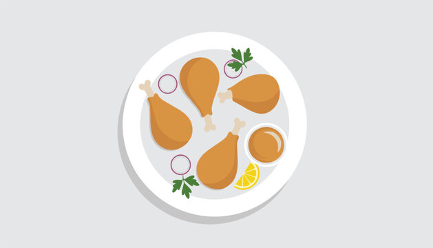 Overhead view of a white plate holding golden fried chicken drumsticks garnished with onion rings, lemon, parsley, and dipping sauce.