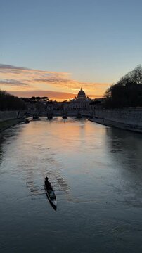 St Peter's Basilica at Sunset in Rome Italy. Tiber River with Row Boat Silhouette. Beautiful City Travel. Shot on Mobile - Vertical Video.