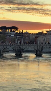 St Peter's Basilica at Sunset in Rome Italy. Slow Pan Right. Tiber River with Row Boat Silhouette. Shot on Mobile - Vertical Video.