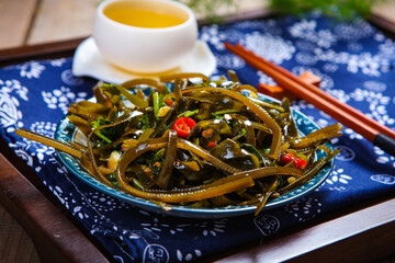 Seasoned cold kelp shred salad on bamboo sushi mat © ads