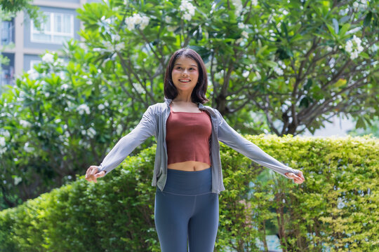 Asian sport woman stretching in park