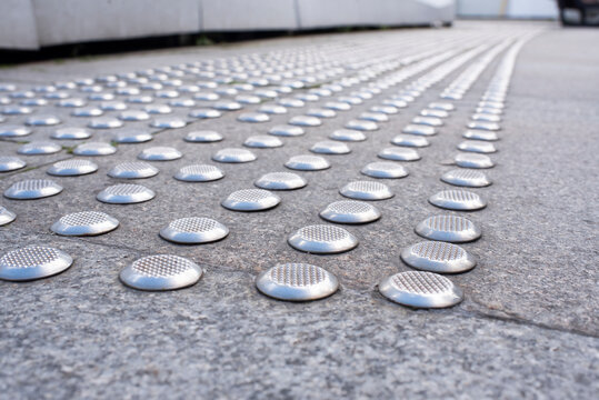 Tactile paving indicators for blind people on city street pavement