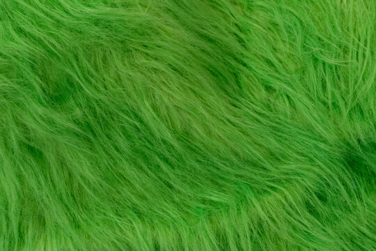 Vibrant green fluffy faux fur texture with soft light and shadow play