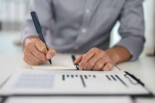 close up hands of Businessman working with analysis report and advisor showing plan, Financial analysts reports and planning investment at office.