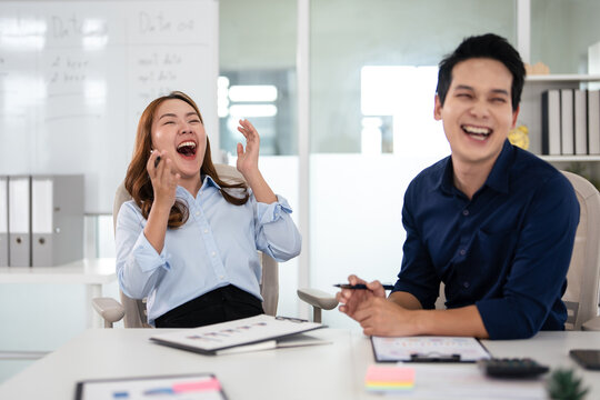 Colleagues having fun at work. positive workflow. Two businessmen laughing together , Friendly professional relations.