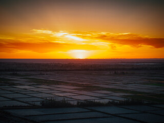 Fototapeta premium Aerial view near Guazhou Service Area Gansu sunset glow over gobi desert with power transmission towers and highway