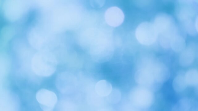 キラキラ輝く雪と水の抽象的な背景、寒色系玉ボケと幻想的な光の冬のバックグラウンド