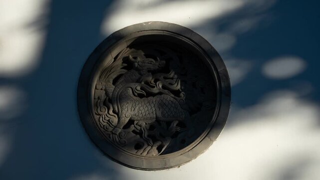 circular stone relief of chinese dragon pattern on traditional architecture in hangzhou